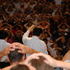 Rev. C.S. Lee having the congregation place their hands on their heads and praying words of blessings over them